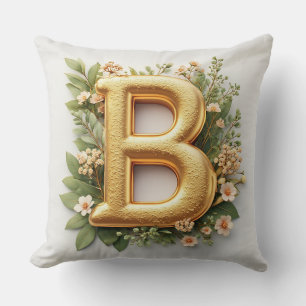 Goldener Buchstabe B umgeben von floralen Arrangem Kissen