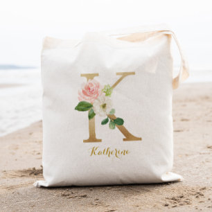 Goldener Buchstabe K und rosafarbene Blumenpersona Tragetasche