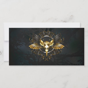 Goldener Vogelschädel auf schwarzem Hintergrund Feiertagskarte