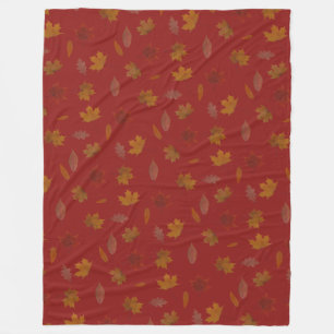 Goldenes Herbst-Blätter auf roter Fleecedecke