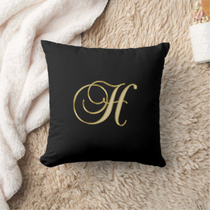 Goldmonogramm H auf schwarz Kissen