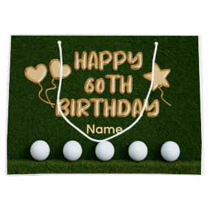 Golf 60. Geburtstag mit Golfbällen auf grünem Gras Große Geschenktüte