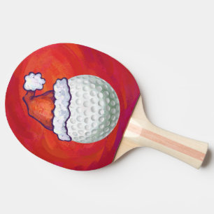 Golf Ball in Weihnachtsmannmütze Tischtennis Schläger