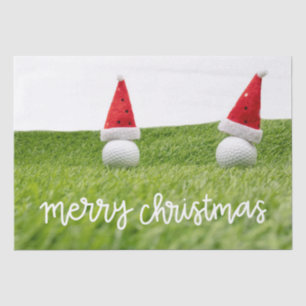 Golf-Ball mit dem Weihnachtsmann-Hut auf grünen We Seidenpapier