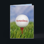 Golf Ball On T-Shirt für Grandson Karte<br><div class="desc">Für Grandsons Geburtstag ist der Golfball auf rotem Tee in grünem Gras nah. Text auf Ball kann bearbeitet werden.</div>