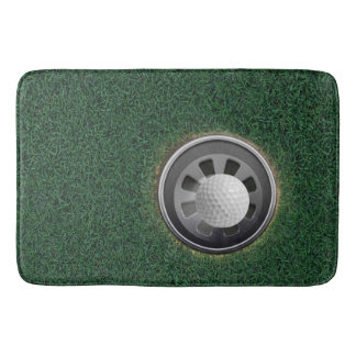 Golfball in der Schale im Gras Badematte