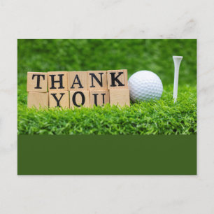 Golfball mit dem Wort Danke auf grünem Gras Postkarte