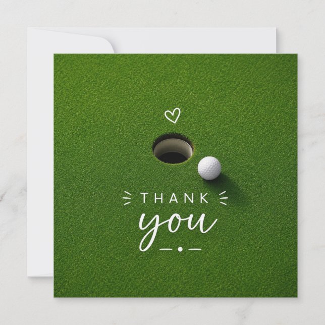 Golfball neben Loch auf grünem Gras Danke  (Vorderseite)