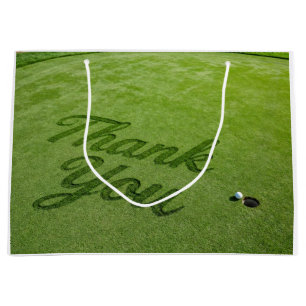 Golfball neben Loch auf grünem Gras Danke Große Geschenktüte