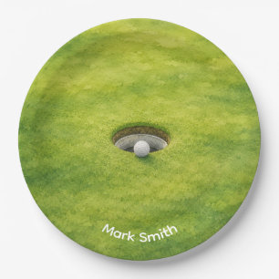 Golfball neben Loch auf grünem Rasen Golfplatz Pappteller