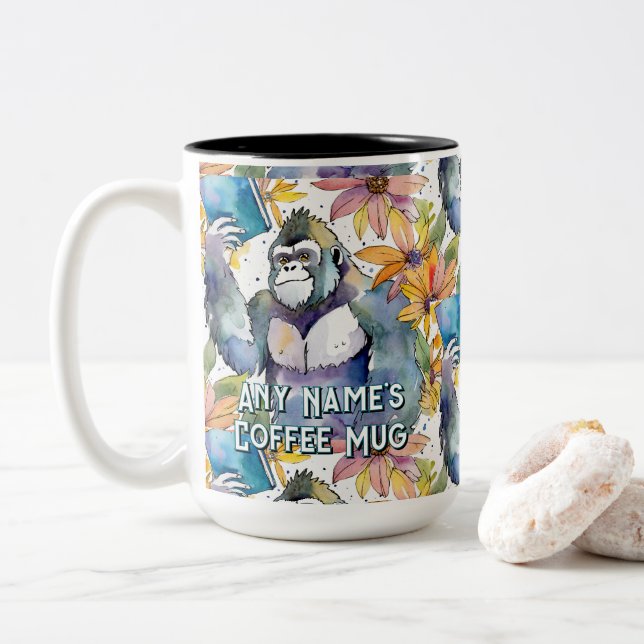 Gorilla hält den Big Book Coffee zwei Tasse (Mit Donut)