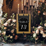 Gothic Black Raven & Black Arch Gold Hochzeit Tischnummer<br><div class="desc">Mit unserer Vintag gotischen Hochzeitskarte bringen Sie Ihre Gäste in eine Welt der dunklen, bezaubernden Eleganz. Der tiefe, gelbe goldene Hintergrund Set die Bühne für einen auffallenden Kontrast, da fett weißer Text aus komplizierten, schwarzen Textfeldern entsteht. Am Höhepunkt dieser Einladung nimmt ein dreidimensionaler gotischer Rahmen mit einem königlich schwarzen gotischen...</div>