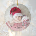 Grandparents First Christmas Photo Black Script Keramik Ornament<br><div class="desc">Help them celebrate their first grandchild with this beautiful modern keepsake ornament. The off-black text reads "Our first Christmas as grandparents, " with the word "grandparents" in elegant handwriting script with flourishes before and after. Easily replace the sample image with your favorite photo of the new baby, and add his...</div>