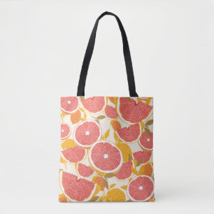 Grapefruit und halbierte Scheiben mit Blätter auf Tasche