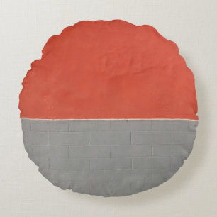 Graue und orangefarbene Wand Rundes Kissen