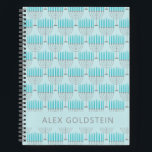 Hanukkah Menorah Blue Personalisiert Kids Name Notizbuch<br><div class="desc">Dieses festliche Notizbuch zeichnet sich durch ein sich wiederholendes Menorah-Muster in hellblau und grau auf einem weichen himmelblauen Hintergrund aus, ideal um den Geist von Hanukkah zu feiern. Die Vorderseite bietet Platz für einen individuelle Name in sauberer, moderner Typografie. Ideal als Urlaubsgeschenk für Kinder, Schüler und Lieben, die während der...</div>