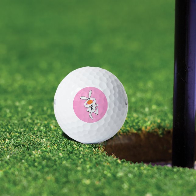 Happy Dancing Niedlicher Cartoon Weißes Kaninchen  Golfball (Cute white bunny thumbs up sign orange nose on pink background on golf balls.)