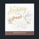 Hedwig Whimsical Forest Drawing Notizblock<br><div class="desc">Show your house spirit in the coziest way with this charming Hedwig™ design. Featuring the beloved snowy owl bundled up in a warm Gryffindor house-colored scarf, this playful illustration captures the magic and loyalty of Harry Potter’s trusted companion. Set against a whimsical woodland backdrop with subtle sparkling accents, the hand-drawn...</div>