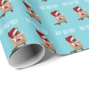 Ho! Ho! Ho! Gerbil in der Weihnachtsmannmütze, im Geschenkpapier