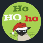 Ho Ho Ho Siamese Cat Christmas Weihnachtsfeiertag  Runder Aufkleber<br><div class="desc">Ho Ho Ho Grouchy Siamese Cat Holiday Stickers. Die lustige Katze trägt einen Weihnachtshut. Diese lustigen Aufkleber eignen sich perfekt,  um die Rückseite der Urlaubshüllungen zu schließen. Besuchen Sie Jenn’s Doodle World für lustigere Katzenfreunde-Produkte und coole Geschenke mit diesem humorvollen Xmas Cat Cartoon.</div>