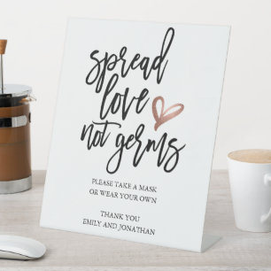Hochzeitspread-Liebe nicht Keime nehmen eine Maske Sockelschild