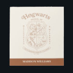HOGWARTS™ School of Witchcraft and Wizardry Crest Notizblock<br><div class="desc">Honor the legacy of the wizarding world with this timeless Hogwarts™ School of Witchcraft & Wizardry crest design. Featuring the iconic four-house shield — lion, serpent, badger, and eagle — this elegant artwork represents the unity and tradition of Gryffindor™, Slytherin™, Hufflepuff™, and Ravenclaw™. Rendered in a refined, vintage-inspired line style,...</div>