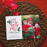 Holly Jolly | Holiday Foto Collage Card Feiertagskarte<br><div class="desc">Festliche Urlaubskarte zeigt Ihr Lieblings-Foto,  rechts ausgerichtet,  mit "ein heiliges Jolly Weihnachten haben" in handgeschriebener Typografie mit rot-grünen heiligen Blätter und Beeren. Personalisieren Sie Ihre Namen unten,  und fügen Sie ein zusätzliches Foto auf der Rückseite hinzu.</div>