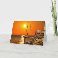 Holzschwung mit Sonnenuntergang über Seeszene