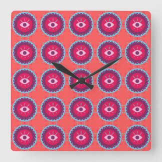 Horloge Carrée Motif oculaire coloré sur Arrière - plan rouge