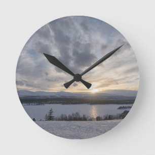 Horloge Ronde Coucher de soleil sur un lac gelé