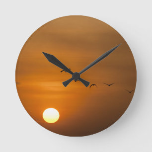 Horloge Ronde Oiseaux volant au coucher du soleil