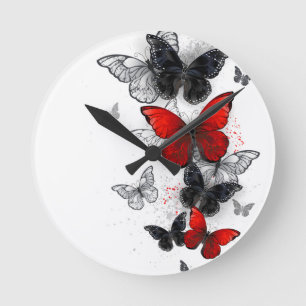 Horloge Ronde Papillons noirs et rouges volants