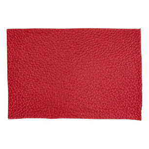Housse D'oreillers Closeup en cuir artificiel rouge foncé.
