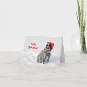 Hund im Schnee mit Santa-Hut und Frohe Weihnachten Karte