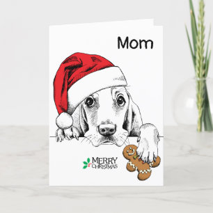 Hunde mit Weihnachtsmannmütze, Pfote auf einem Leb Karte