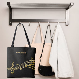 Imitate goldene Musiknoten auf einem schicken schw Tasche