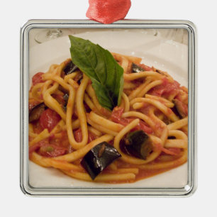 Italien, Positano. Teller mit Pasta und Aubergine. Silbernes Ornament