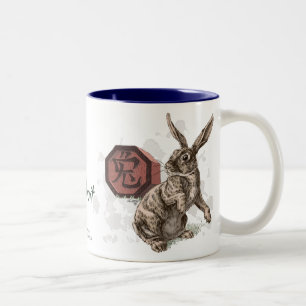 Jahr der Kaninchen-Chinesischen Zodiakkunst Zweifarbige Tasse