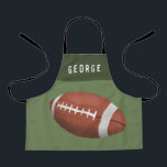 Jungs Niedlich Moderne Fußballsportkids Schürze<br><div class="desc">Dieses niedliche Schürze-Design für Jungs mit Sportmotiven ist mit einem amerikanischen Cartoon ausgestattet und kann mit dem Namen Ihrer Jungs personalisiert werden. Ideal für sportbegeisterte Kinder,  die Liebe kochen und Gärtnern!</div>