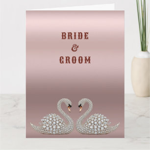 Juwelen-Hochzeitsschwäne bilden ein Herz auf Rosa Karte