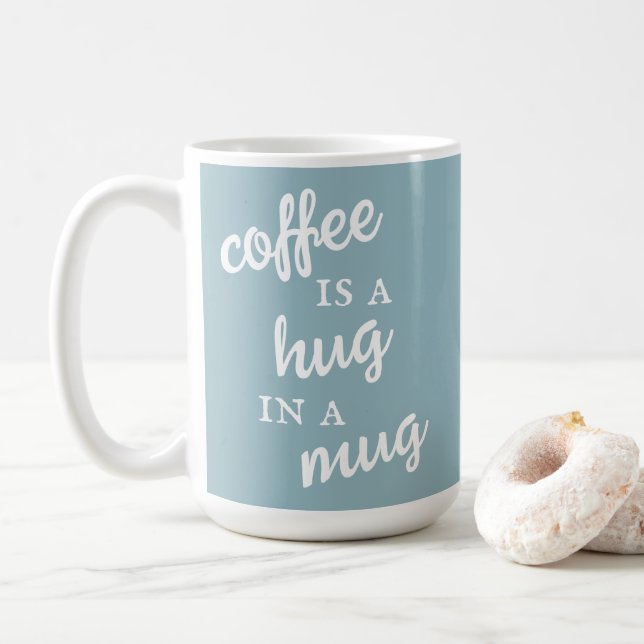 Kaffee ist ein Umarmer in einer Tasse Mute Blue Ta (Mit Donut)