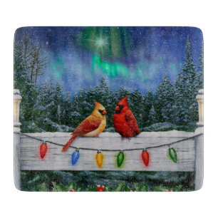 Kardinal und Weihnachtslicht Winterschnee Schneidebrett
