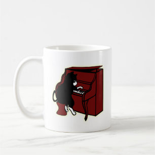 Katze, die Klavier-Tasse spielt Kaffeetasse