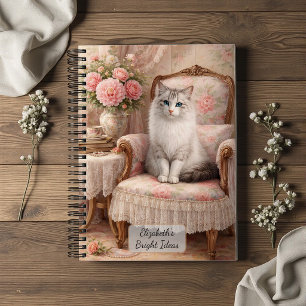 Katze in floralem Sessel Notizbuch