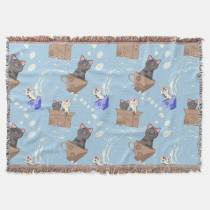 Katzen in Kiste und Milchfallen auf blau Decke