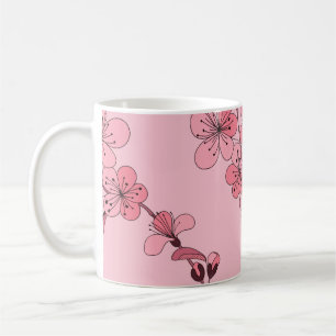 Kirschblüte in rosa Farbe auf weißem Hintergrund. Kaffeetasse