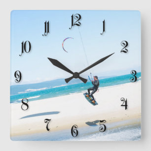 Kitesurfer boosts an air quadratische wanduhr