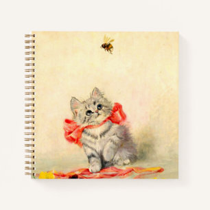 Kitten mit einem roten Band Notizbuch