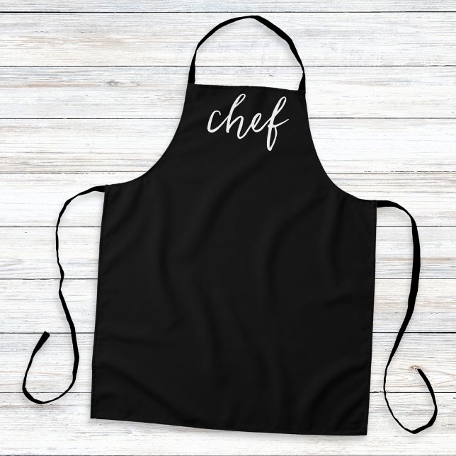 Klassisch Schwarzes Minimales Einfaches Stylisches Schürze (A stylish, minimalist, black kitchen apron with the word 'chef' in white script typography)