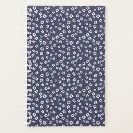 Kleine weiße Blume auf einem blauen Planer